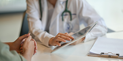 Doctor and patient looking at tablet